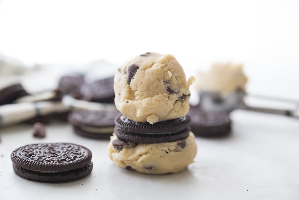 Jumbo Oreo Stuffed Chocolate Chip Cookies Two cookie dough balls surrounding an oreo cookie