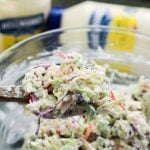 Classic Creamy Cole Slaw - cole slaw mixed up with a wooded spoon - family fresh meals