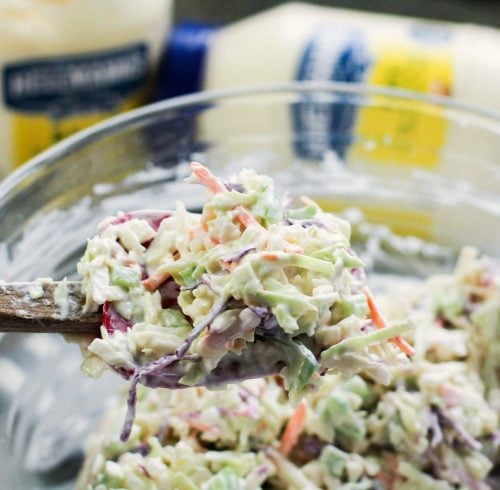 Classic Creamy Cole Slaw - cole slaw mixed up with a wooded spoon - family fresh meals