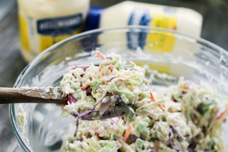 Classic Creamy Cole Slaw - cole slaw mixed up with a wooded spoon - family fresh meals