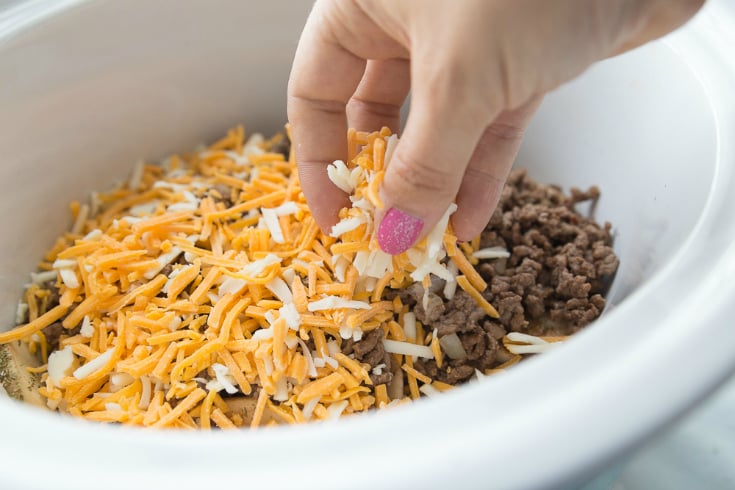 Crockpot Cheesy Cowboy Potatoes - Potatoes topped with cooked beef and shredded cheeseCrockpot 
