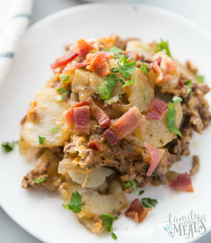 Crockpot Cheesy Cowboy Potatoes - Served on a white plate