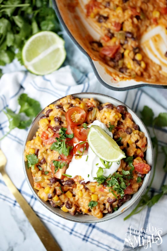 Enchilada Orzo Recipe - Served in a bowl, topped with sour cream, tomatoes, lime and cilantro - Family Fresh Meals