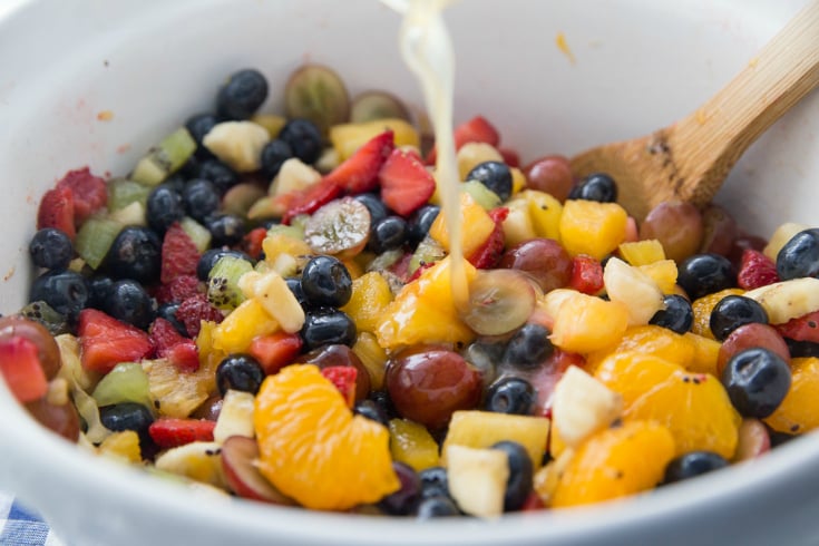 Honey Glazed Fruit Salad - mixed fruit in a white bowl with honey dressing