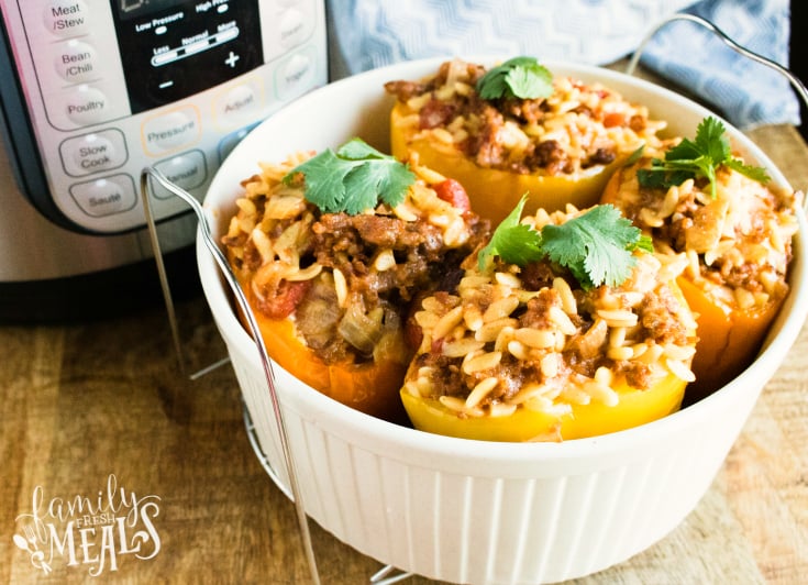 Instant Pot Orzo Sausage Stuffed Peppers - Stuffed peppers in a white casserole dish