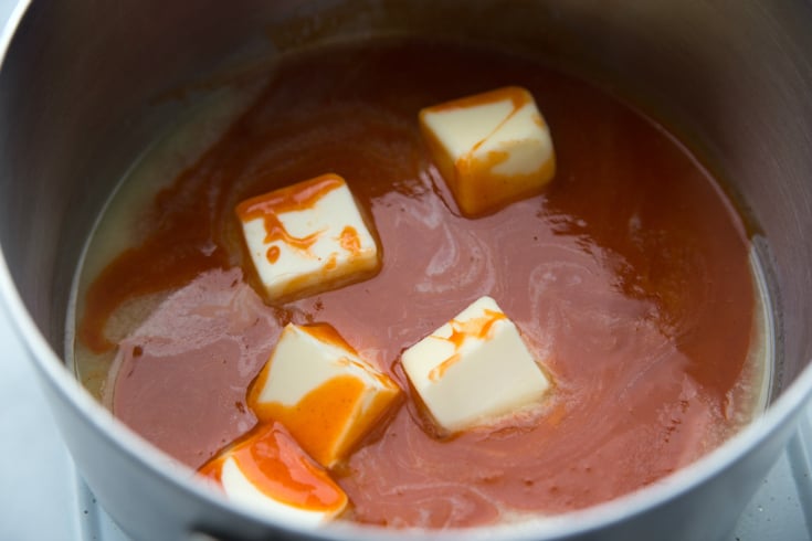 Buffalo Ranch Crack Pretzels - Buffalo sauce and butter in a sauce pan