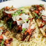 Bruschetta Chicken Recipe Served on a bed of pasta - Family Fresh Meals