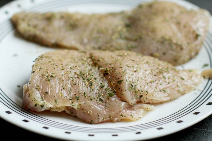 Easy Bruschetta Chicken - Raw chicken on a white plate