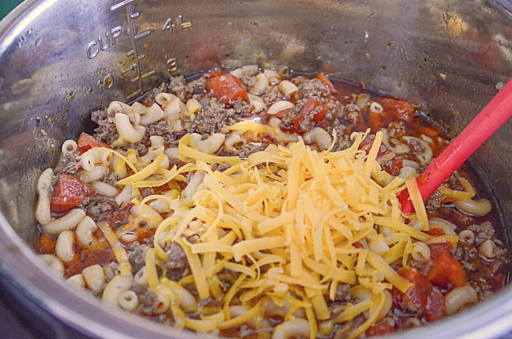 Instant Pot Goulash - Shredded cheese place on top of beef and noodles