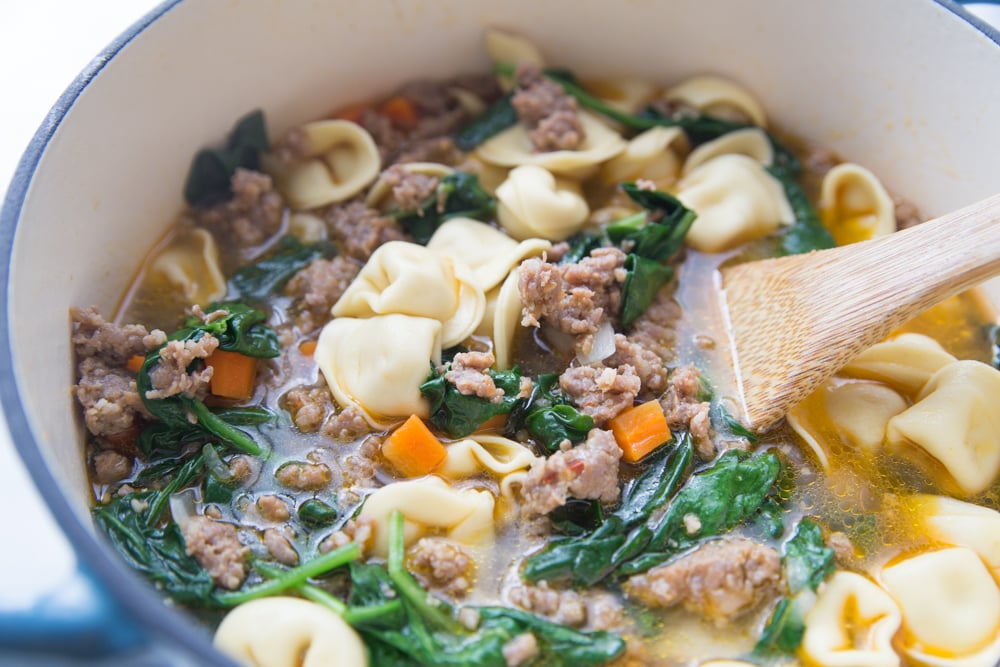 Italian Tortellini Soup Recipe - Stirring in spinach into the soup