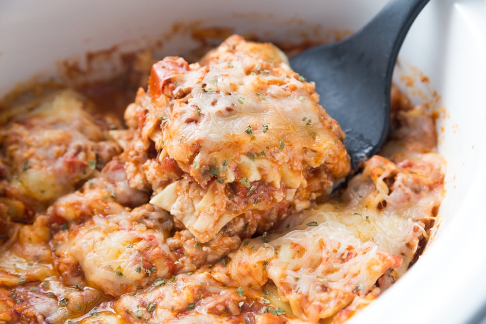 Grandma's Crockpot Lasagna - Family Fresh Meals Recipe - Scooping out a slice of lasagna