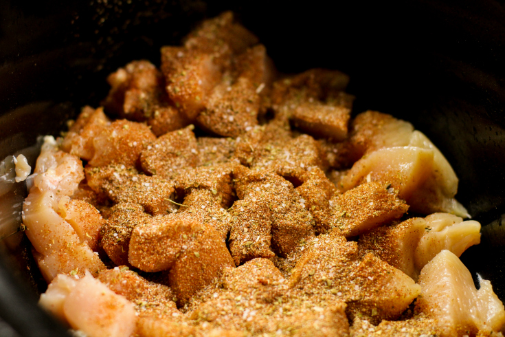 Crockpot Cowboy Chicken Chili Mac - Chicken in crockpot, topped with seasonings