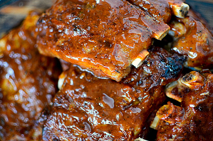 Instant Pot Baby Back Ribs - bbq ribs stacked on baking sheet