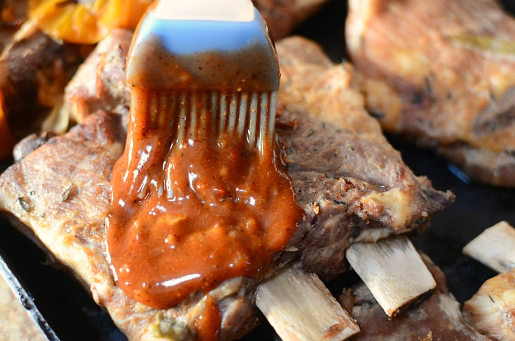 Instant Pot Baby Back Ribs - brushing bbq sauce on cooked ribs