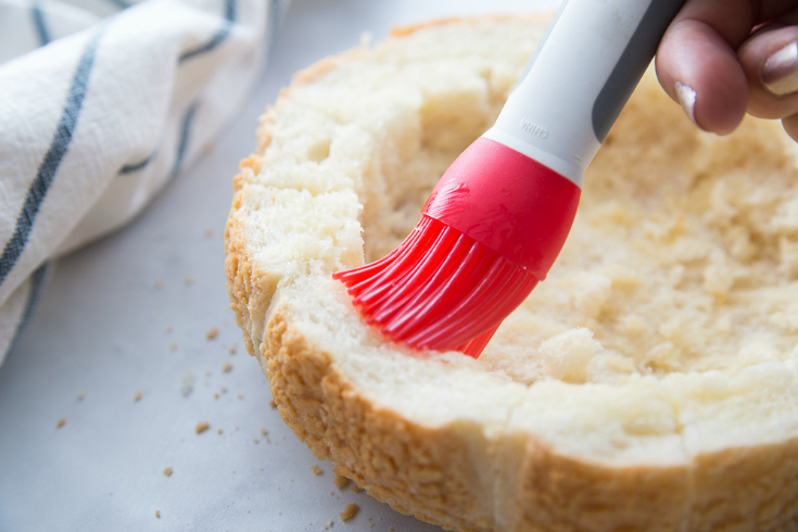 Pull Apart Cranberry Brie Bread Bowl - Brushing bread bowl with oil