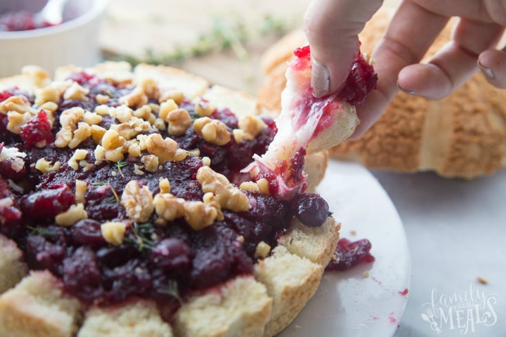 Pull Apart Cranberry Brie Bread Bowl - Pulling off a piece of bread and cheese- Family Fresh Meals