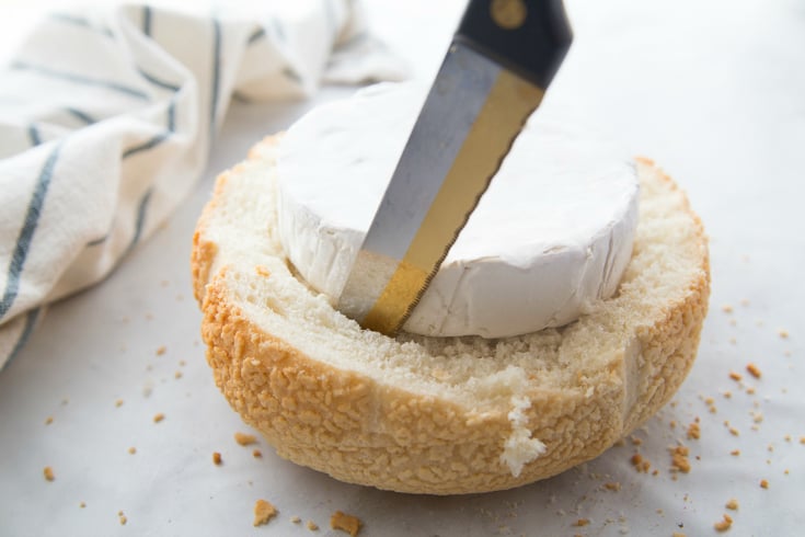 Pull Apart Cranberry Brie Bread Bowl - cutting out bread bowl to fit brie cheese wheel