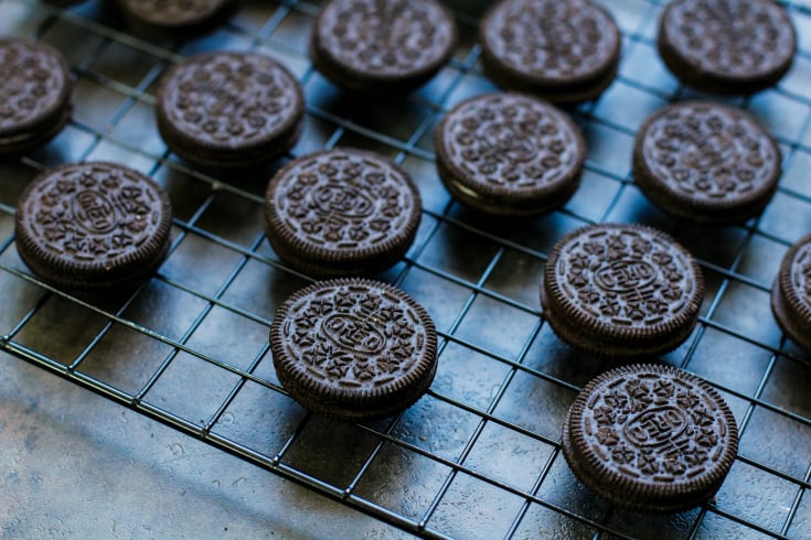 Spooky Halloween Oreos - Oreo cookies laid out on a drying rack