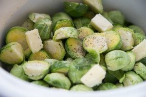 Brussels sprouts, butter and seasoning in the crockpot