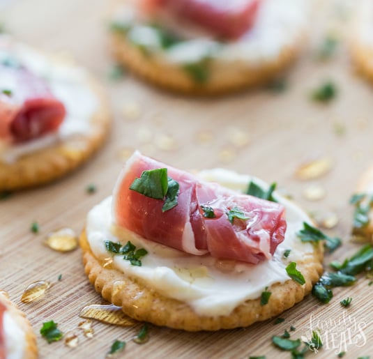 Easy Creamy Prosciutto Crackers on a cutting board