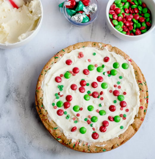 Holiday Sugar Cookie Cake - frosted cookie cake with m&ms on top