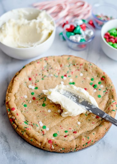 Holiday Sugar Cookie Cake - frosting the top of the cookie cake