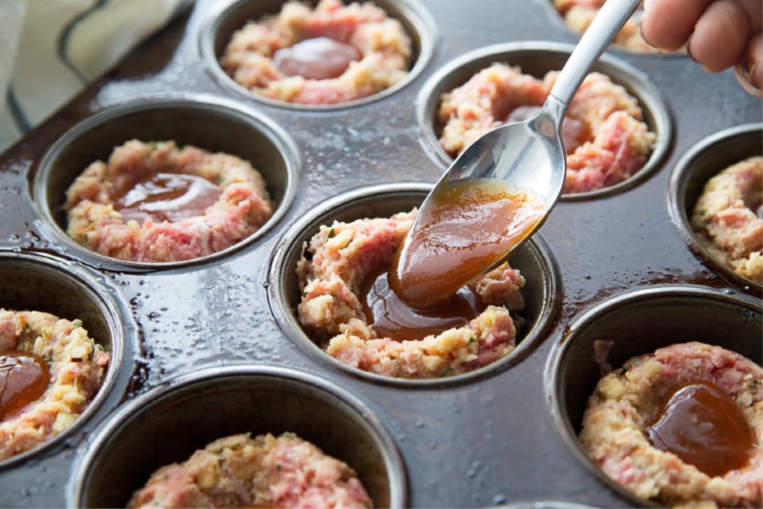 Mini Meatloaf Cupcakes - placing bqq sauce in the middle of the meatloaf