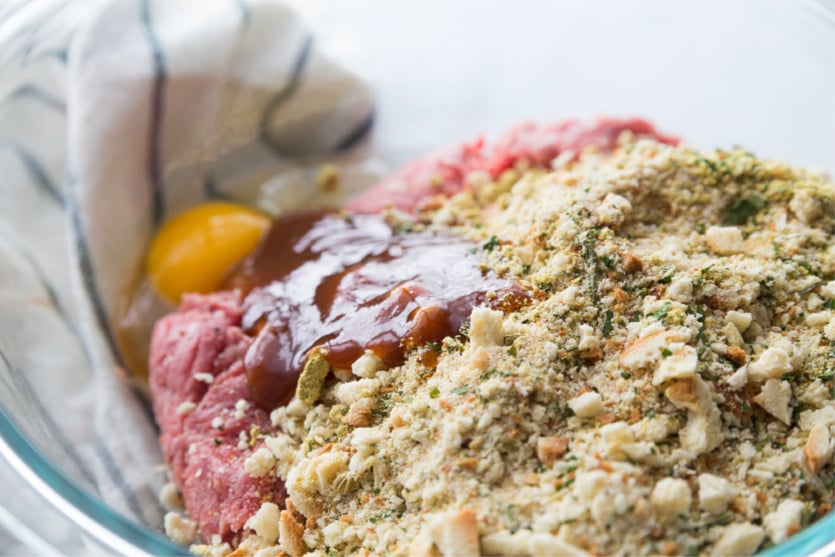 Mini Meatloaf Cupcakes - stuffing, ground beef, egg and seasoning in a glass bowl