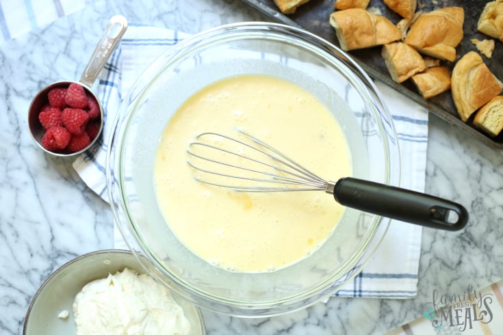 Raspberry Cheesecake Breakfast Bake - egg mixture beaten in a bowl with a whisk