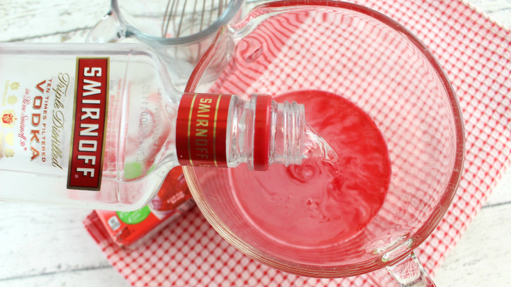Santa Hat Holiday Jello Shots - pouring water and vodka into jello mix
