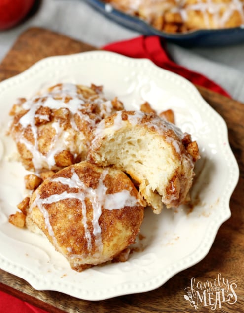 Skillet Apple Pie Dessert Biscuits - Biscuits served on a white plate with a bite taken out