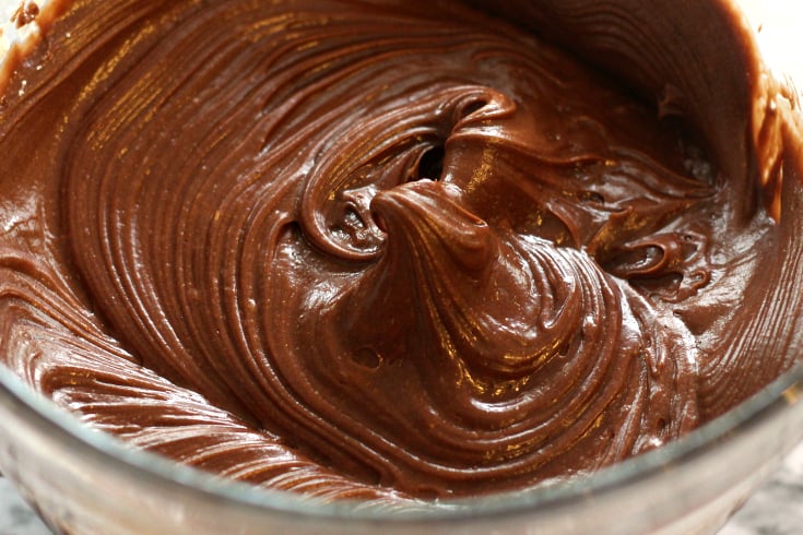 Sour Cream Chocolate Cake - Chocolate frosting in a mixing bowl