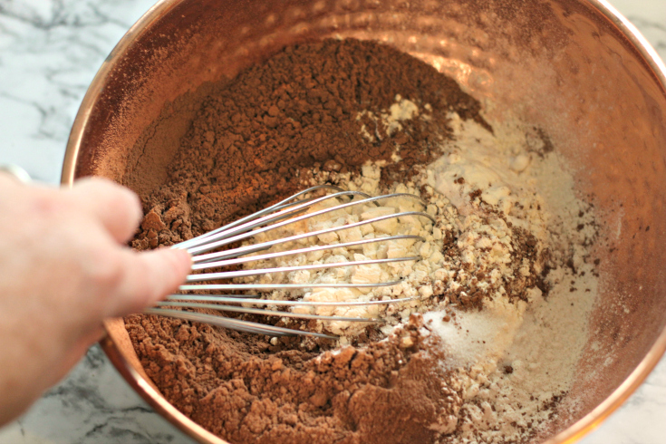 Sour Cream Chocolate Cake - Mixing dry ingredients in a bowl with whisk