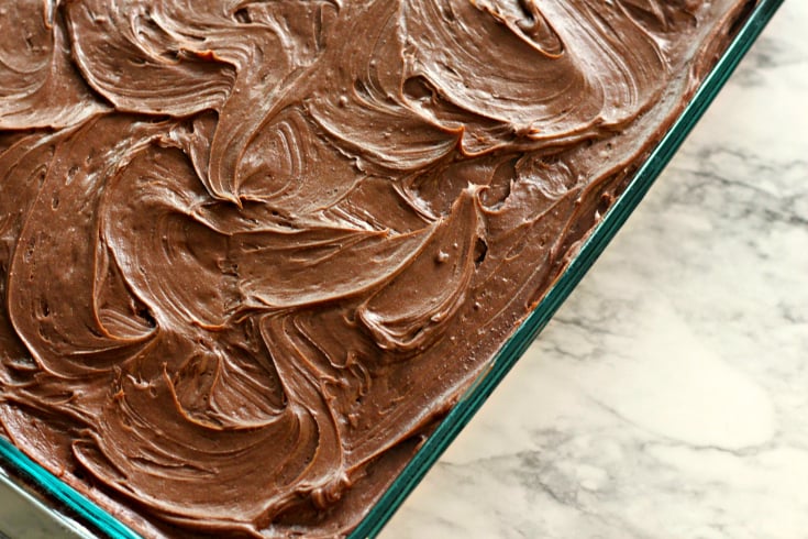 Sour Cream Chocolate Cake - frosted cake in a glass baking pan
