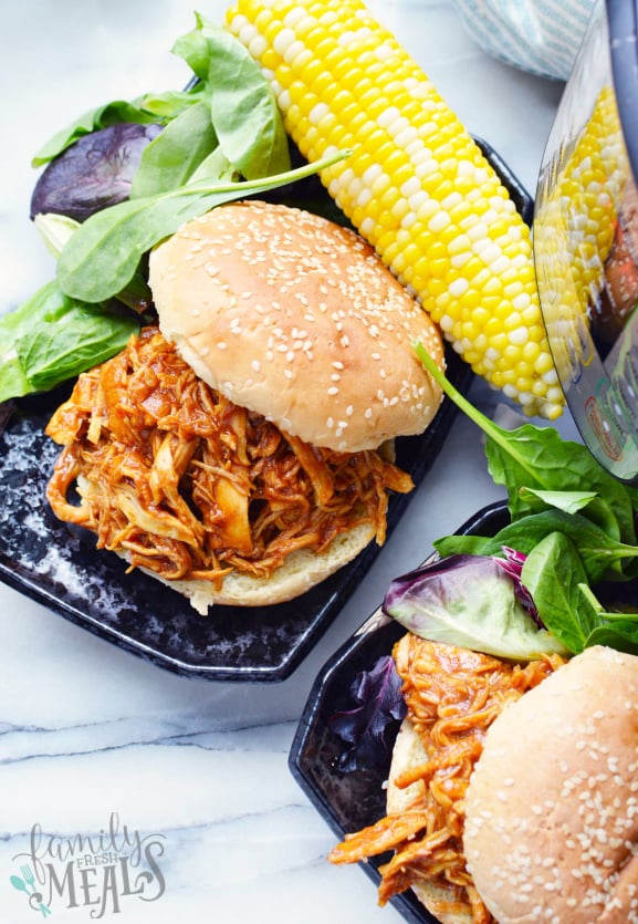 Instant Pot BBQ Chicken - BBQ chicken served on a bun with lettuce and corn - Family Fresh Meals