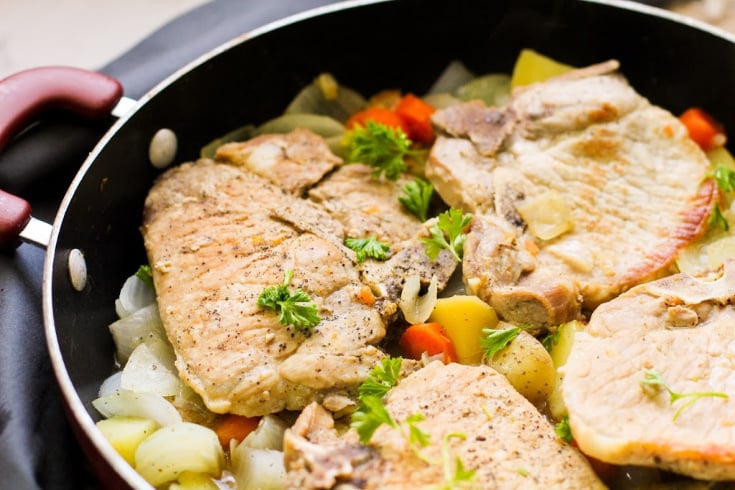 One Pot Pork Chops and Vegetables - cooked pork chops on bed of chopped vegetables