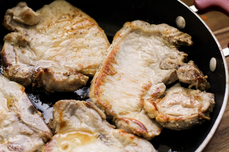 One Pot Pork Chops and Vegetables - pork chops cooking in a pan