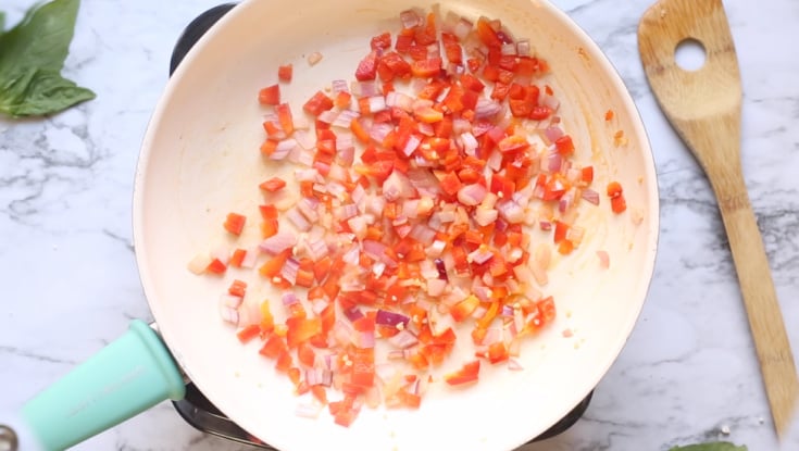 Thai Basil Cauliflower Rice - cooking onions and bell peppers in a frying pan