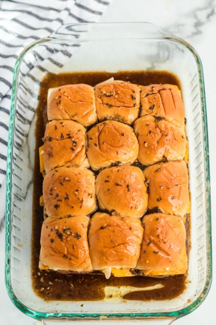 Cheesy Guinness Beef Sliders - slider ready for the oven in a glass pan - Family Fresh Meals