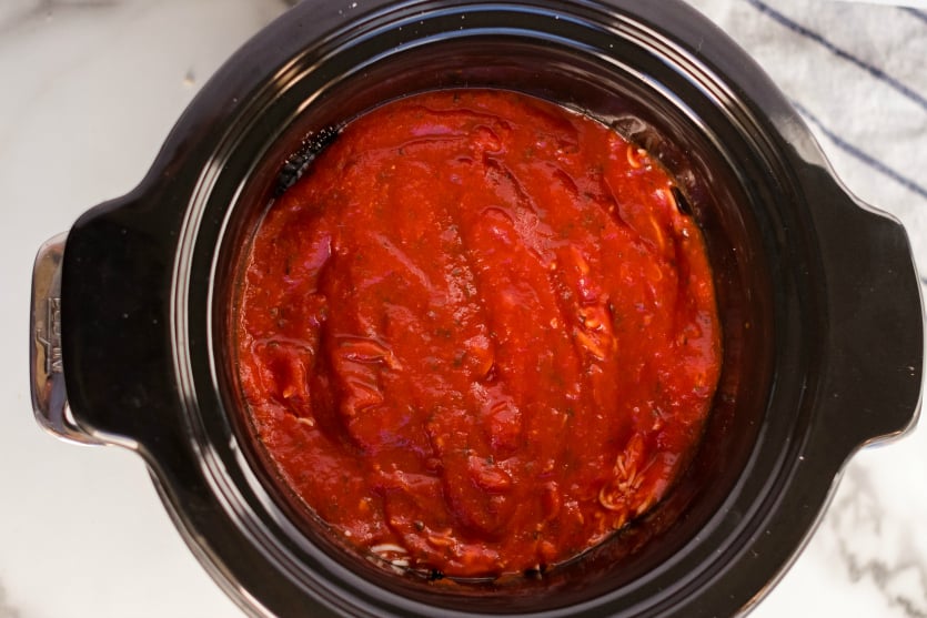 Crockpot Chicken Parmesan - Chicken covered with spaghetti sauce in a slow cooker