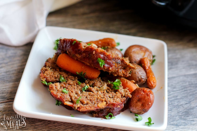 The Best Crockpot Meatloaf Dinner Recipe - slice of meat loaf dinner served on a white plate - Family Fresh Meals