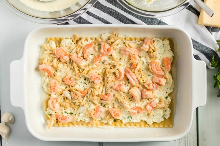 Easy Seafood Lasagna - crab and shrimp placed on top of cheese mixture - Family Fresh Meals