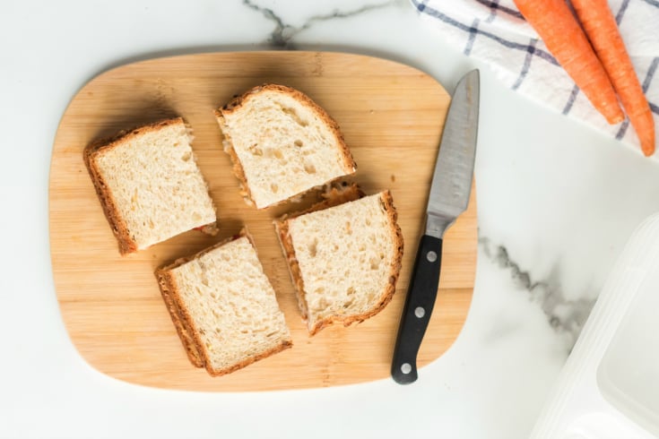 Peanut Butter Jelly Protein Box - sandwich on cutting board with knife