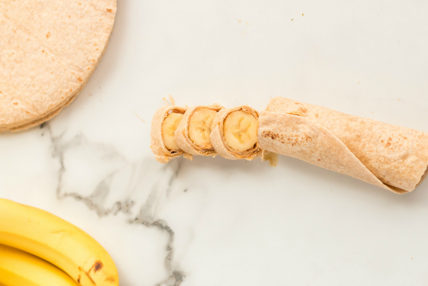 Banana Roll Up Lunch Box Idea - banana and peanut butter wrapped in tortilla and sliced - Family Fresh Meals