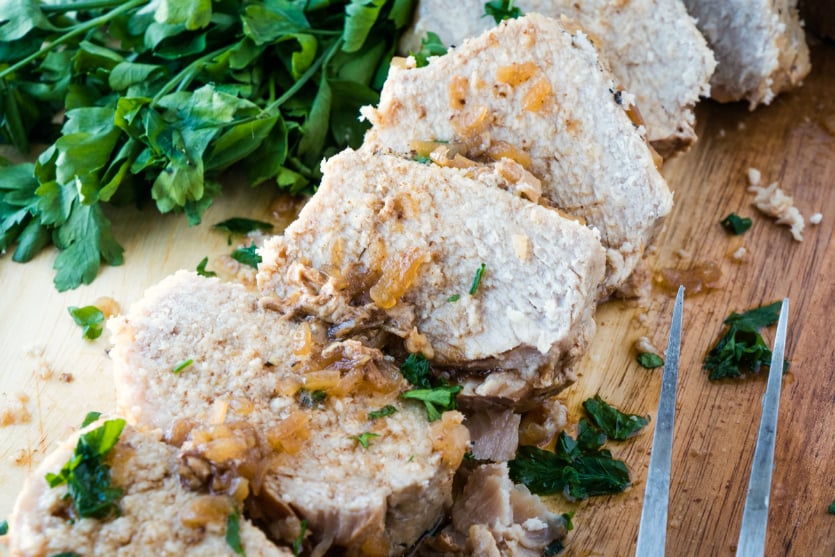 Crockpot Pork Loin - roasted pork sliced on cutting board - Family Fresh Meals