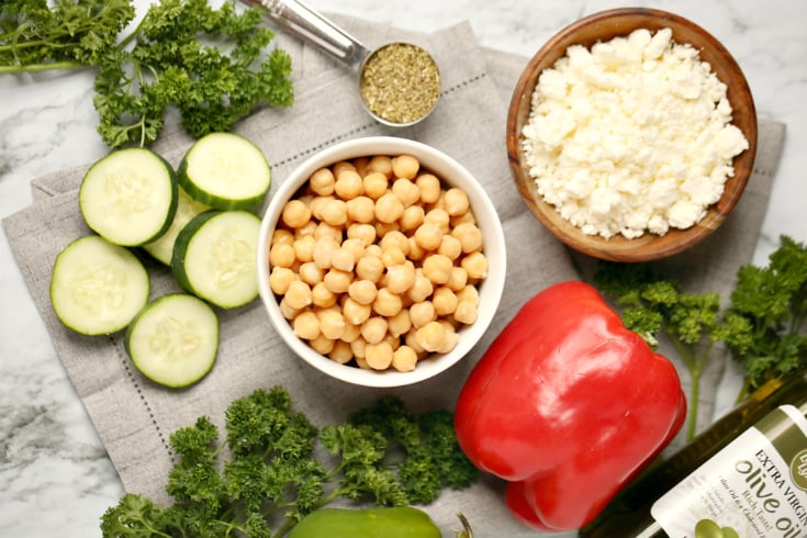 Cucumber Chickpea Salad - Ingredients on counter chickpeas, cheese, bell pepper, cucumbers, olive oil, seasoning - Family Fresh Meals