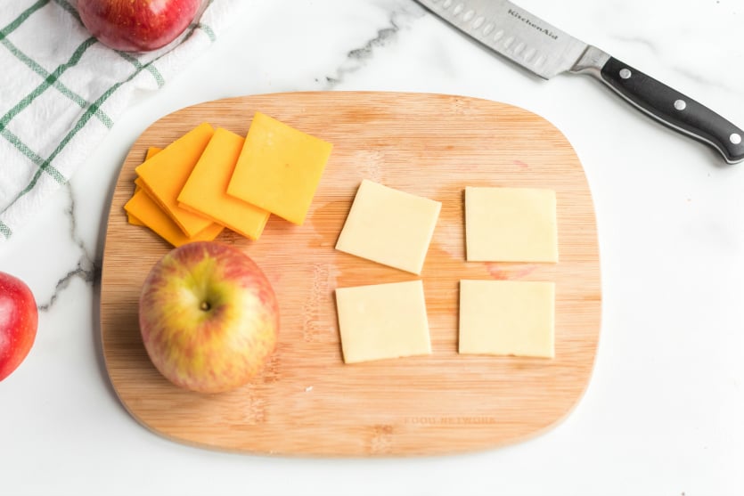 DIY Cheese and Crackers Lunchables - cheese slices on a cutting board - Family Fresh Meals