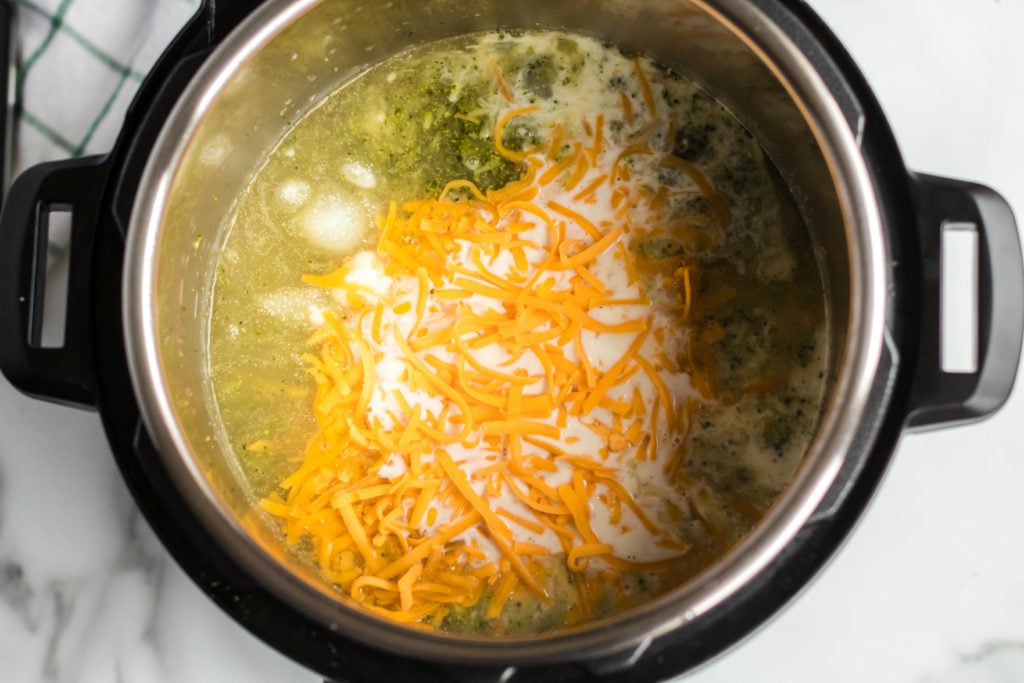Instant Pot Broccoli Cheddar Soup - cheese and milk mixture placed in pressure cooker - Family Fresh Meals