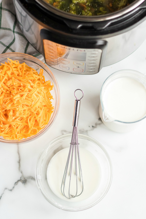 Instant Pot Broccoli Cheddar Soup -milk and cheese in mixing bowls - Family Fresh Meals