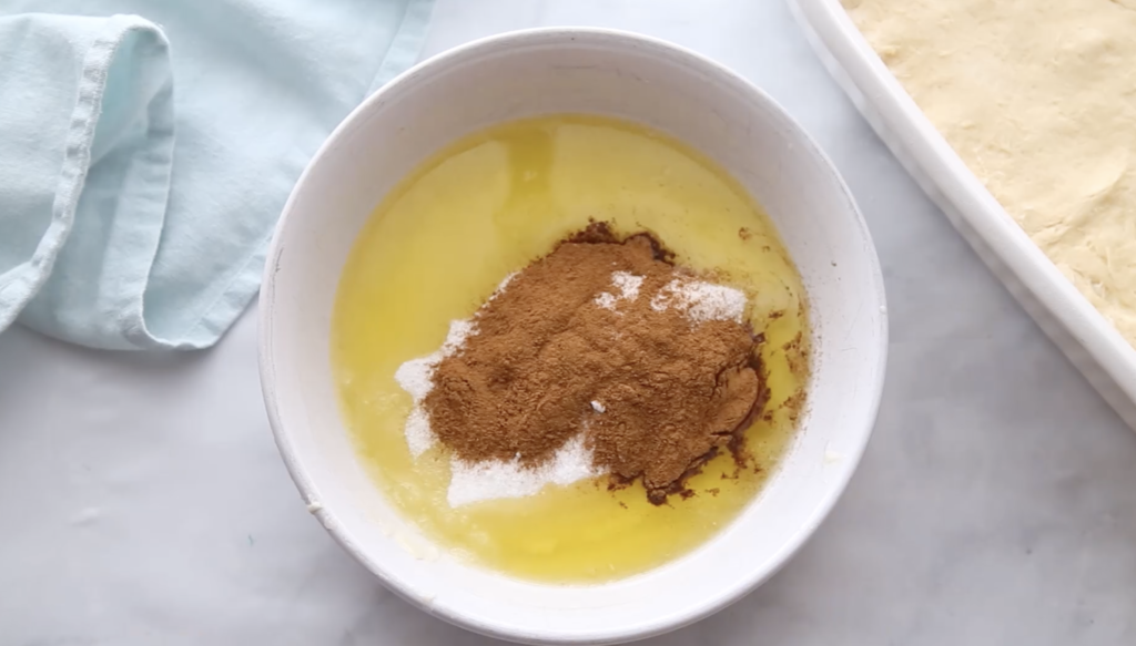 Churro Cheesecake Bars - Mixing butter, cinnamon and sugar mixture